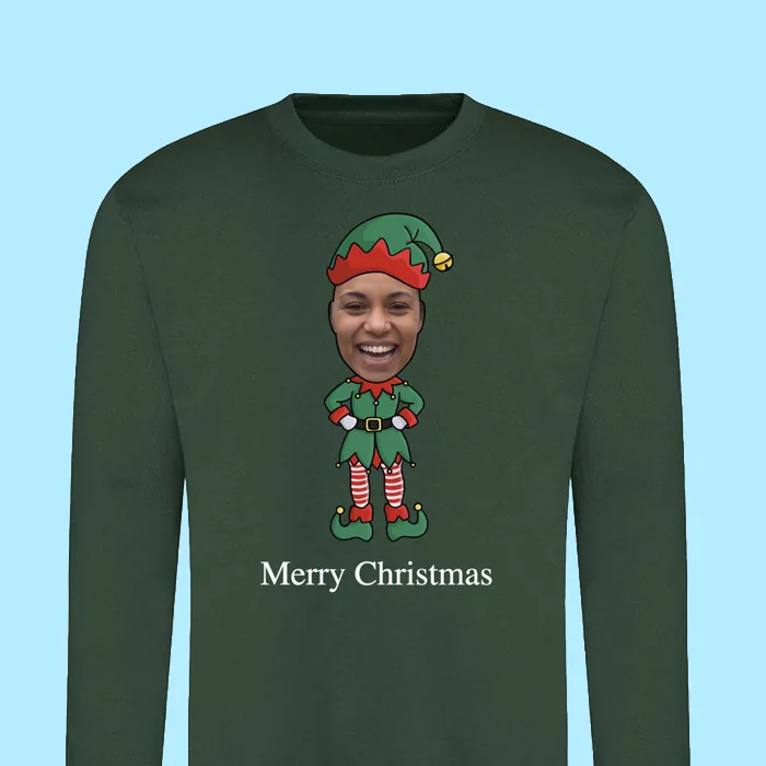 A green Christmas jumper printed with the elf character and the words Merry Christmas