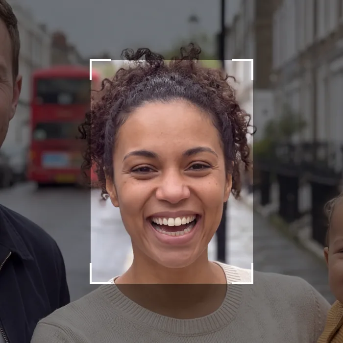 A smiling selfie framed by a face-crop box, taken on a London street